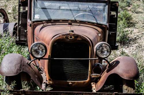 Antique Car In A Scrap Yard Photo