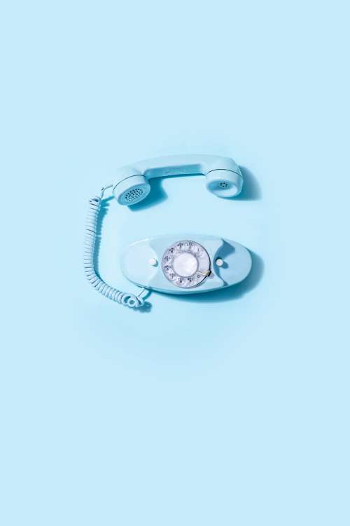Blue Vintage Rotary Telephone Laid On Blue Background Photo
