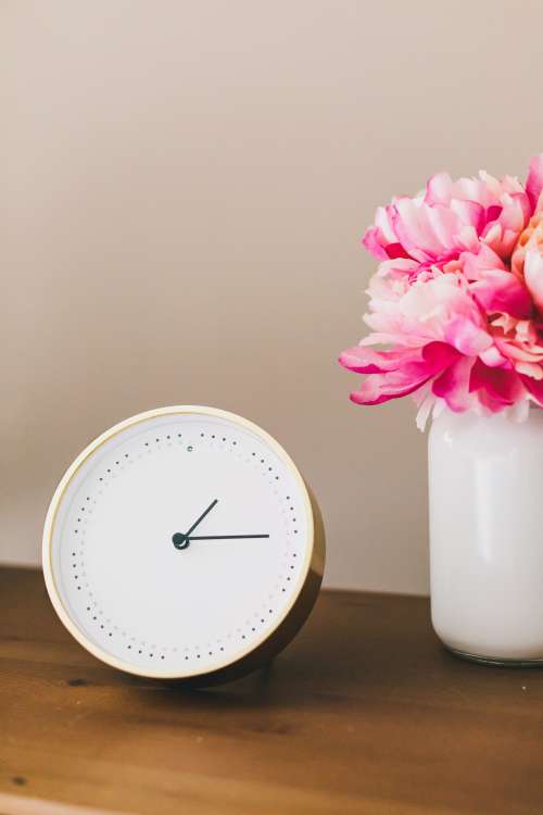 Clock And Flowers On Side Table Photo