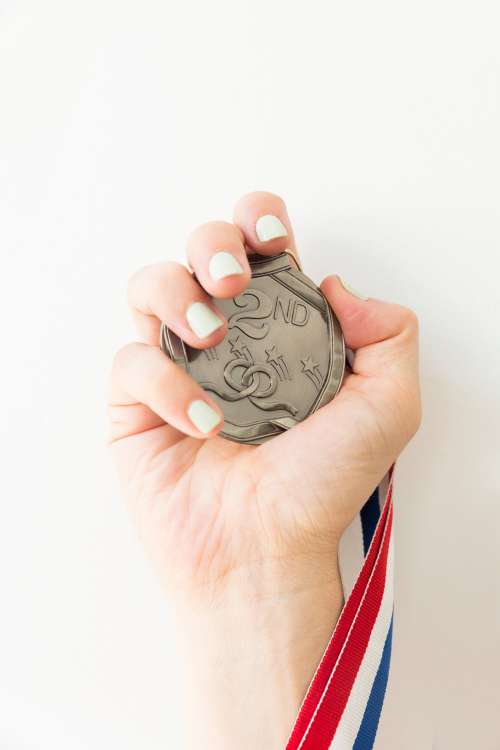Hand Holds Medal Photo