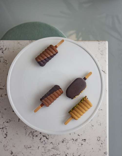 Ice-creams Covered In Chocolate And Nuts Photo