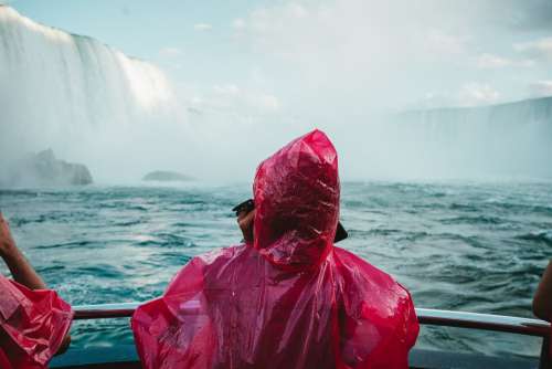 Red Poncho Blue Waterfall Photo