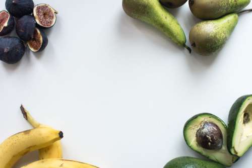 Aerial shot of fresh figs, bananas, pears and avocados