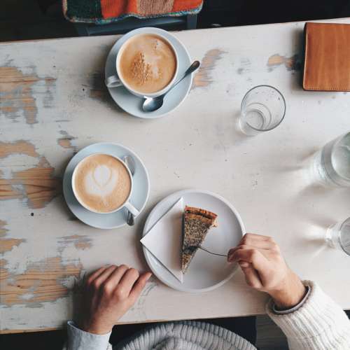 White and brown coffee with cake scene