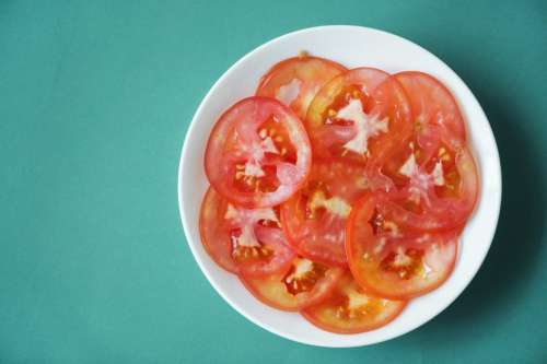 Close up of tomato slices on white plate