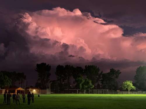 Storm Clouds Glow over Green Grass