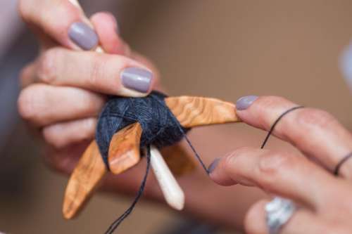 Hands of woman spinning yarn