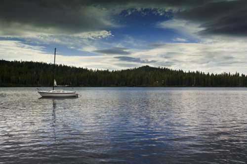 peaceful lake with sailboat in California