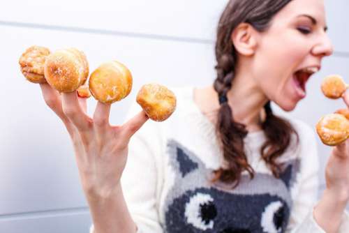 Woman with Donut Fingers Free Photo 