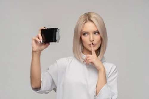 Young Attractive Woman Holding Vintage Camera Like Doing Selfie