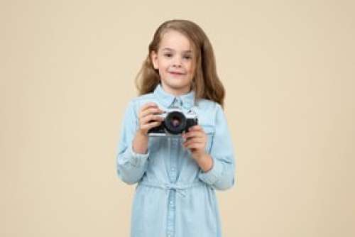 Cute Little Girl Holding A Camera