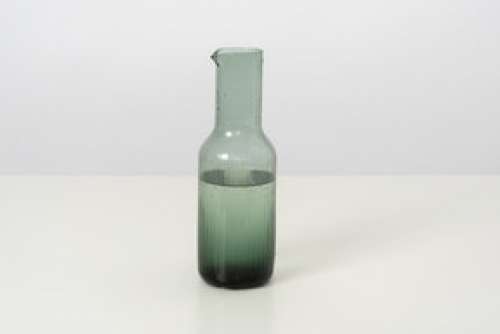 A Glass Bottle Of Cold Water, Designed In A Simple Style And Form