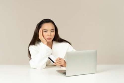 Upset Young Asian Woman Doing Online Shopping