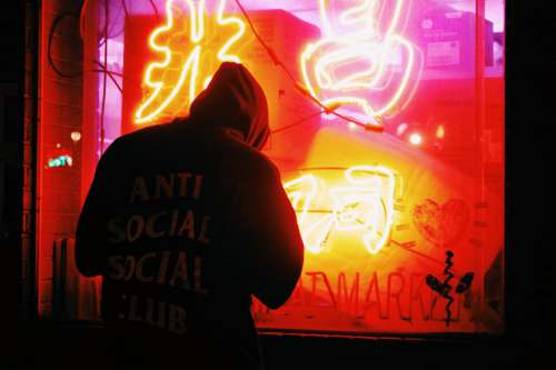 Man by Neon Sign