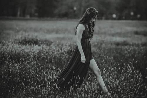 Woman Walking in Field