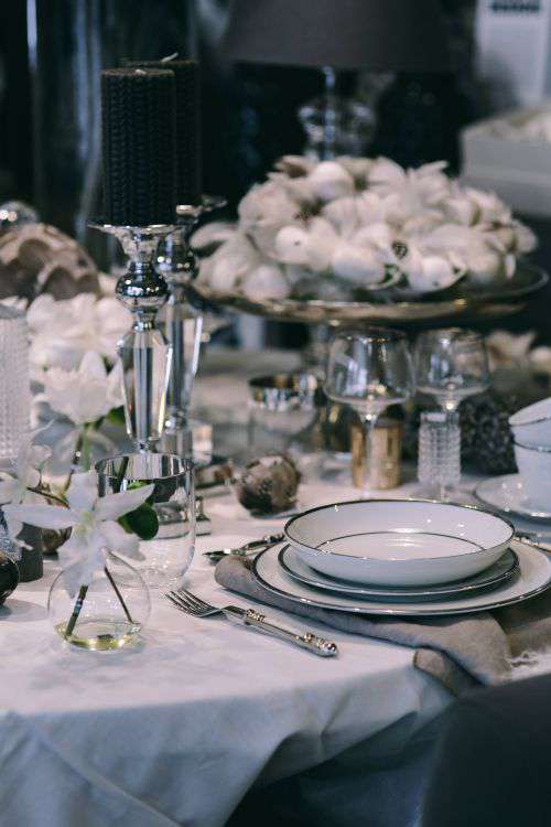 Fancy restaurant dinner table decorated with quail eggs and feathers