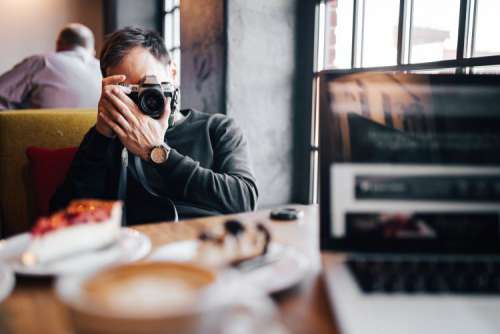 Young Elegantly dressed man sititng in a cafe