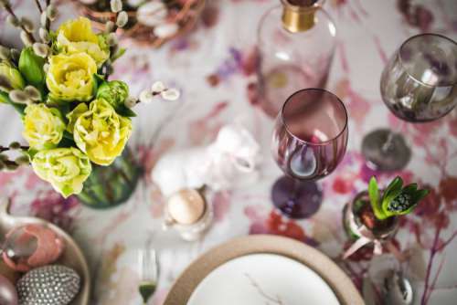 Easter table with cute pink decorations, flowers, catkins and eggs