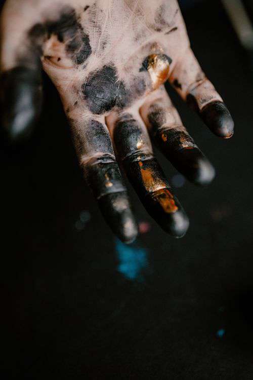 Messy painted hands of a painting artist