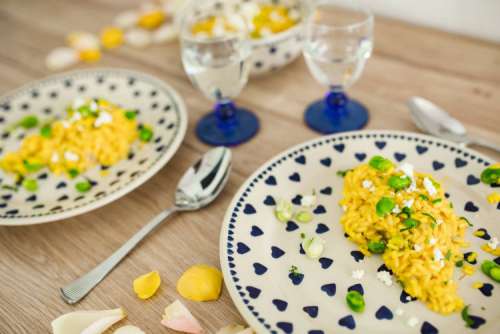 Risotto with broad bean on a cute plate with blue hearts