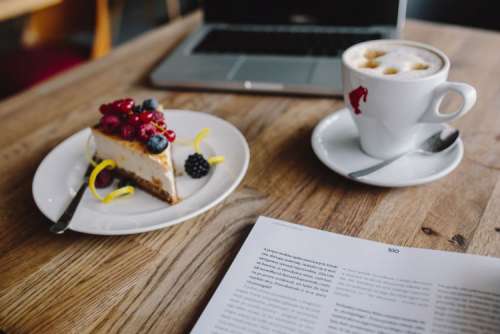 Working in a restaurant: Macbook, Cheese Cake and Cup of Coffee