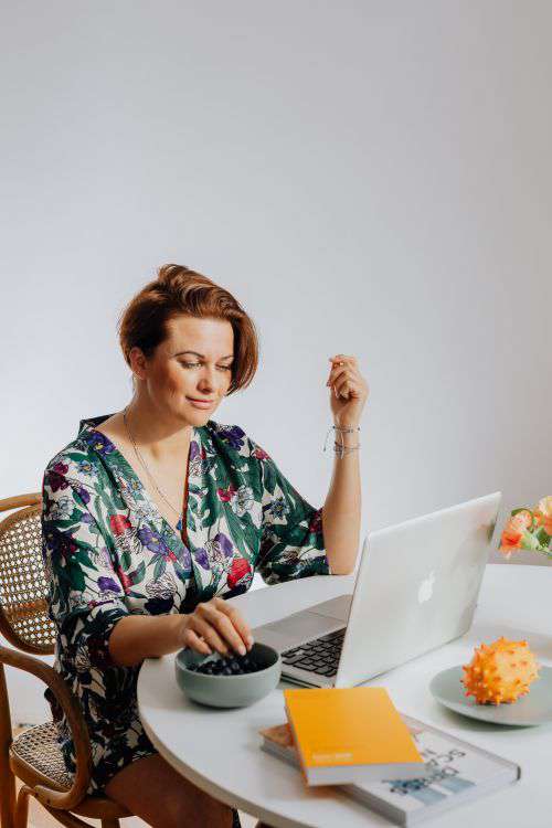 A woman works on a laptop at home