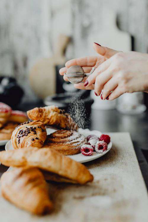 Croissants, puff pastry, powdered sugar and raspberries