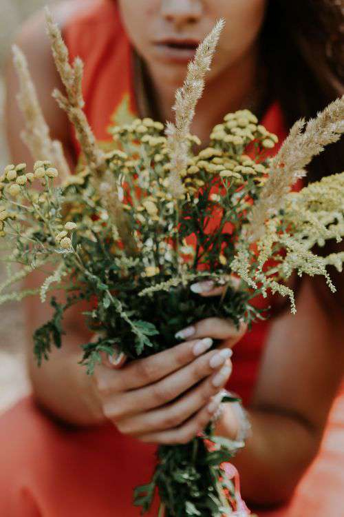 Woman in a red dress with flowers outdoors