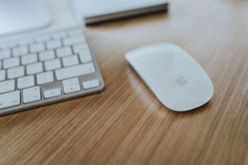 White Apple iMac computer with elephant mousepad