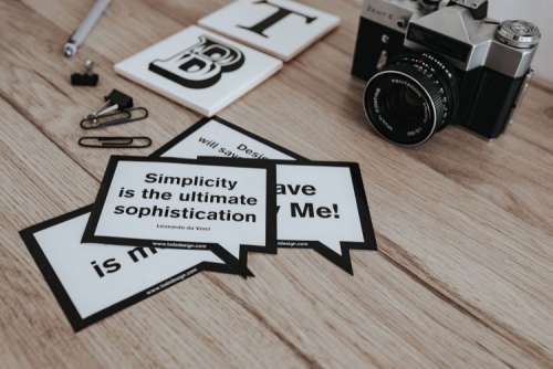 Little cards with inspirational quotes and a black camera