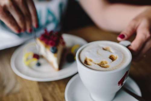 Cup of coffee and berry cheesecake