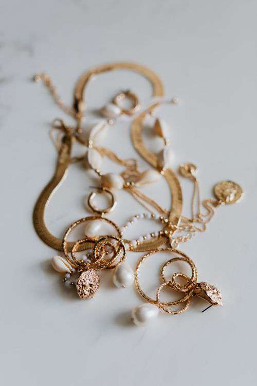 Gold jewelry on white marble