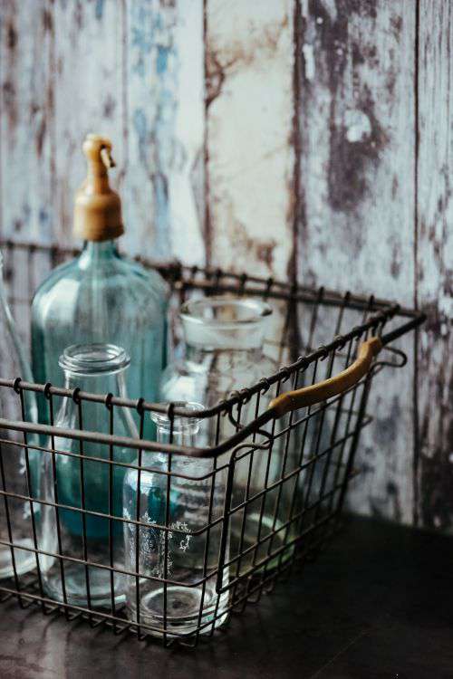 Collection of bottles in metal mesh basket