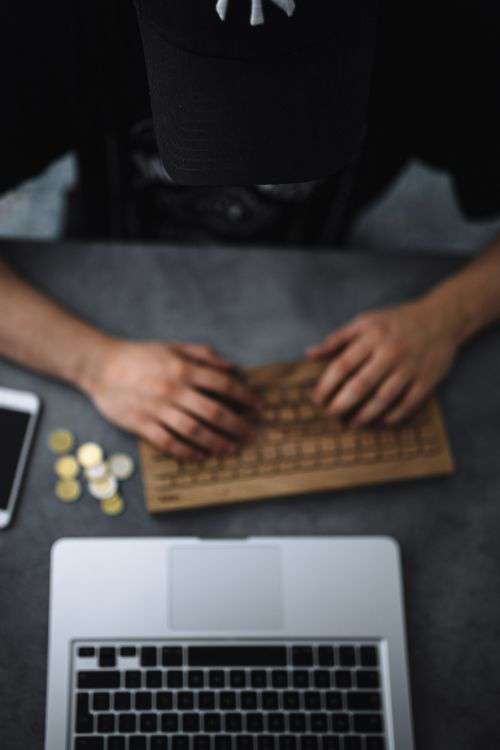 Young man typing on the wooden keyboard