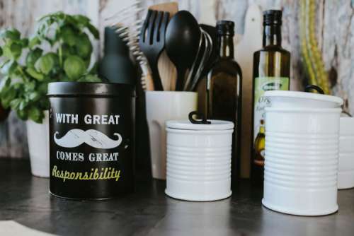 Kitchen utensils and cans by the wall