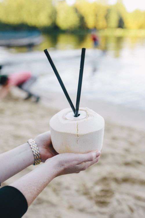 Female holding a fresh coconut