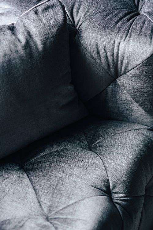 Close-ups of pillows and a grey sofa
