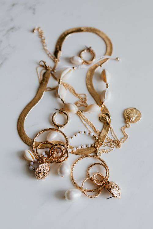 Gold jewelry on white marble