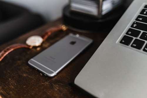 Apple iPhone 6 and Vintage watch on a brown leather wallet