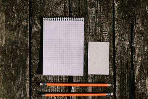 White smartphone with various items on a wooden background