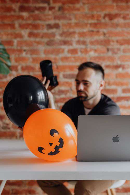 The photographer works at his desk during Halloween