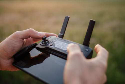 Man holding remote controller for drones flying