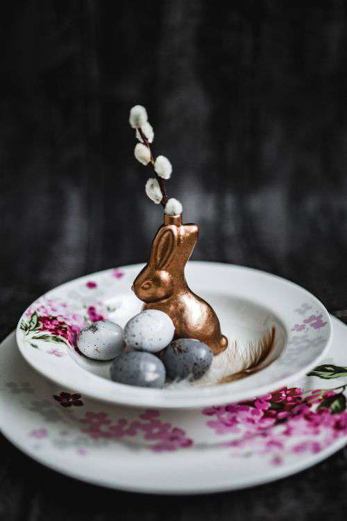 Round dinner table decorated with easter motifs