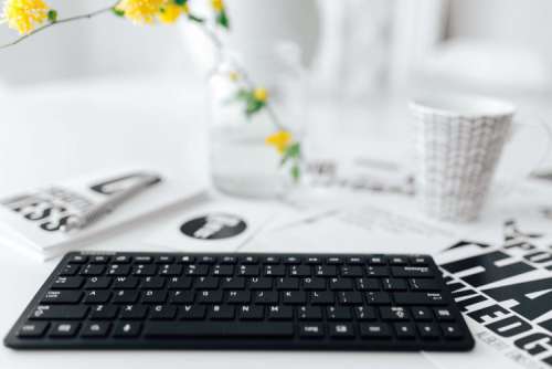 Female hands typing on the remote wireless computer keyboard