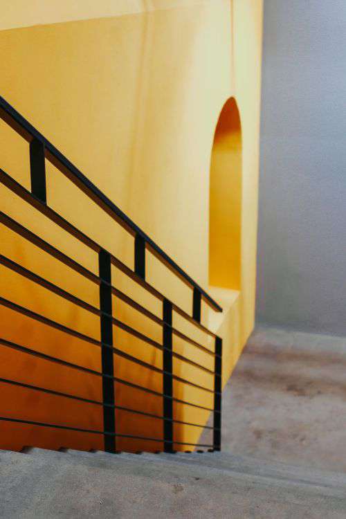 Staircase by a yellow wall