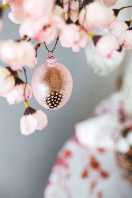 Easter table with cute pink decorations, flowers, catkins and eggs