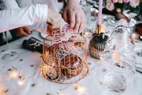 Hands Decorating Christmas Table