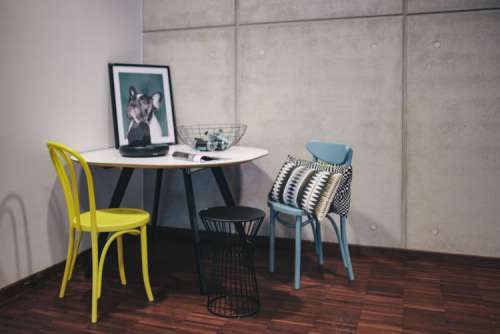 Collection of chairs and tables arranged at a design exhibition