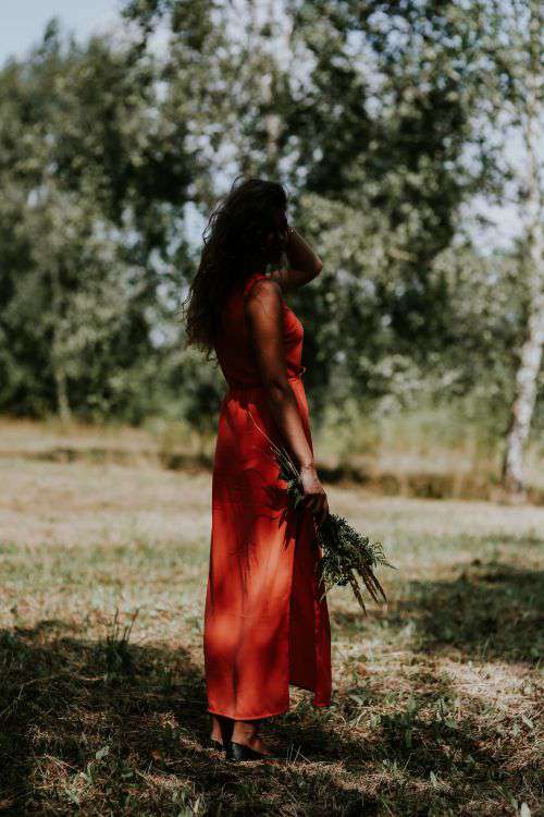 Woman in a red dress with flowers outdoors