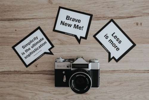 Little cards with inspirational quotes and a black camera